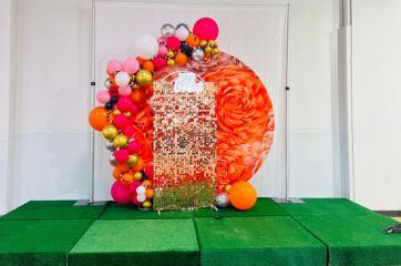 Orange flower champagne mosaic with balloon arch stage decor